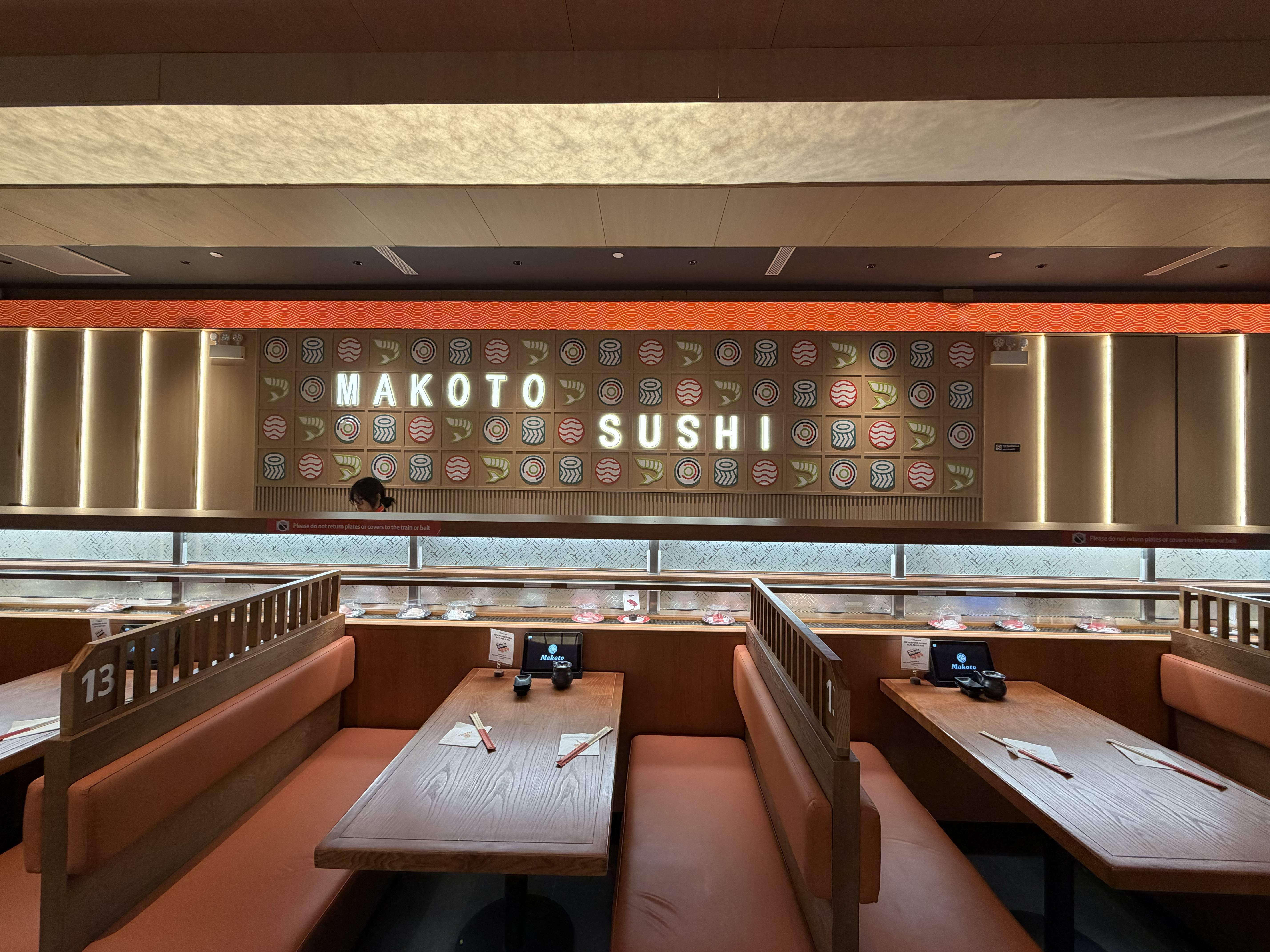 Family-friendly Makoto Sushi dining booths with sushi pattern feature wall in Staten Island