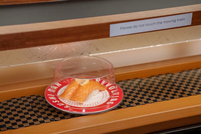 Covered plate of fried bites circling the conveyor belt at Makoto Staten Island