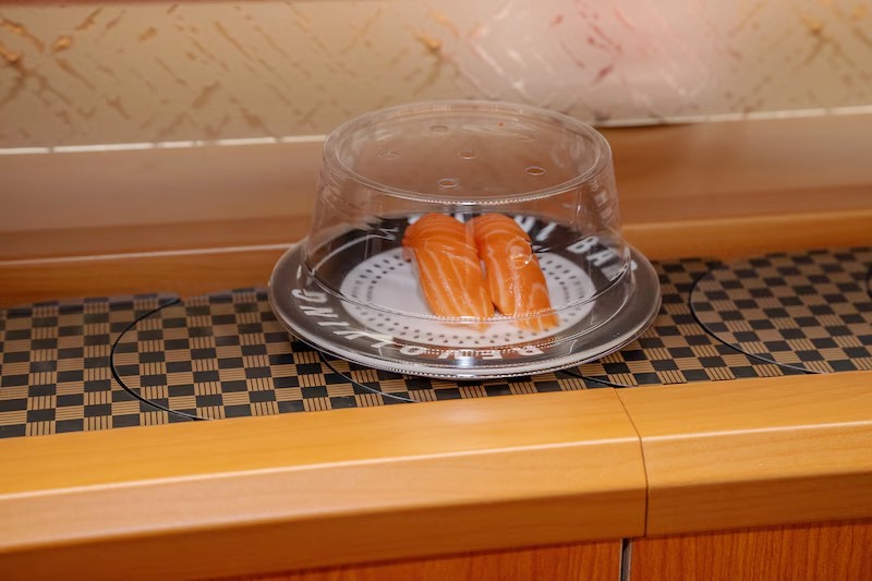 Covered plate of salmon nigiri on the conveyor belt at Makoto Staten Island