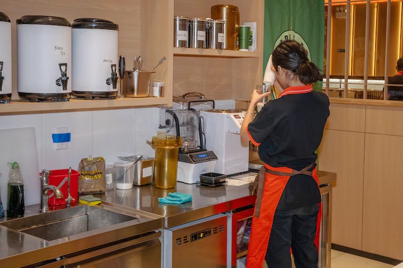 Makoto staff preparing drinks at the tea bar in Staten Island