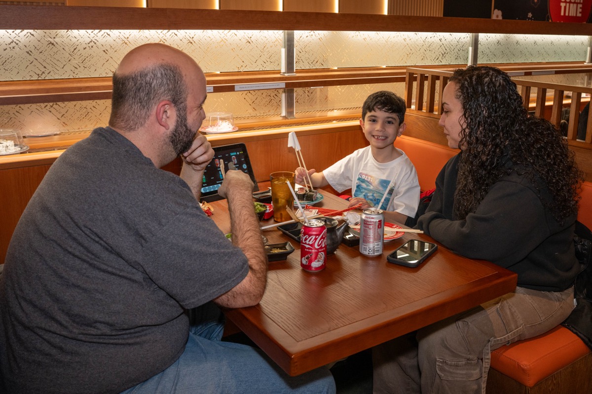 Joe and Rachel DiBlasi and their son Sonny, 8, dine at Makoto Revolving Sushi in New Dorp, Staten Island