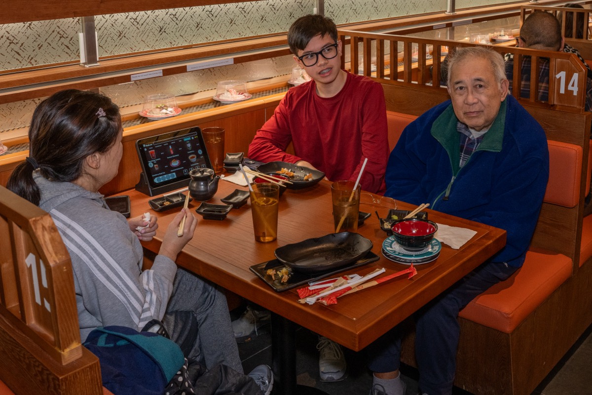 Irene Zak, Noah Zak, 14, and Rufino Sandoval, 81, dine at Makoto Revolving Sushi in New Dorp, Staten Island