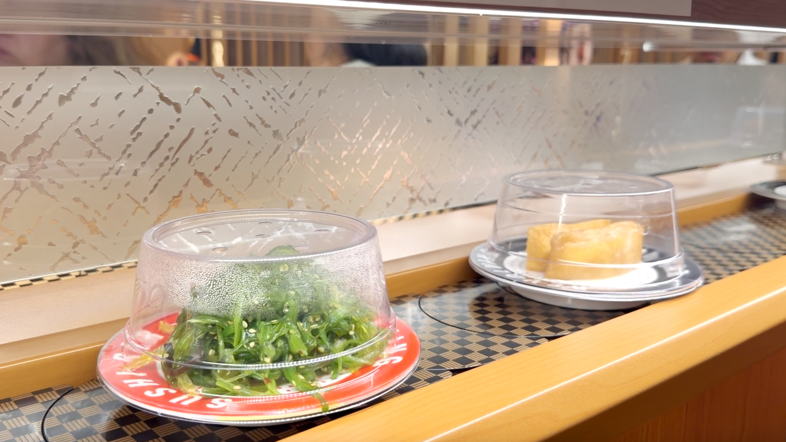 Seaweed salad on the belt Chuka wakame seaweed salad and inari pouch plate on the belt at Makoto Staten Island